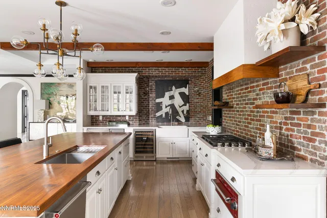 a bathroom with a granite countertop sink a mirror and a shower