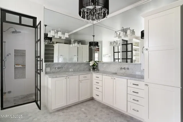 a kitchen with stainless steel appliances a stove refrigerator and white cabinets