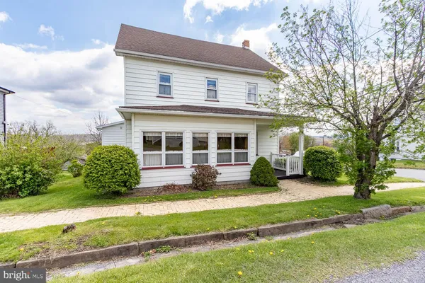 a view of a house with a backyard