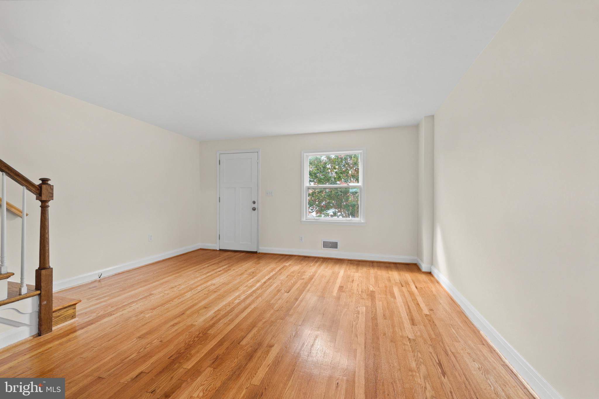 2207 Hawthorne Road Baltimore, MD 21220 - Photo 7 of 39 an empty room with wooden floor and windows