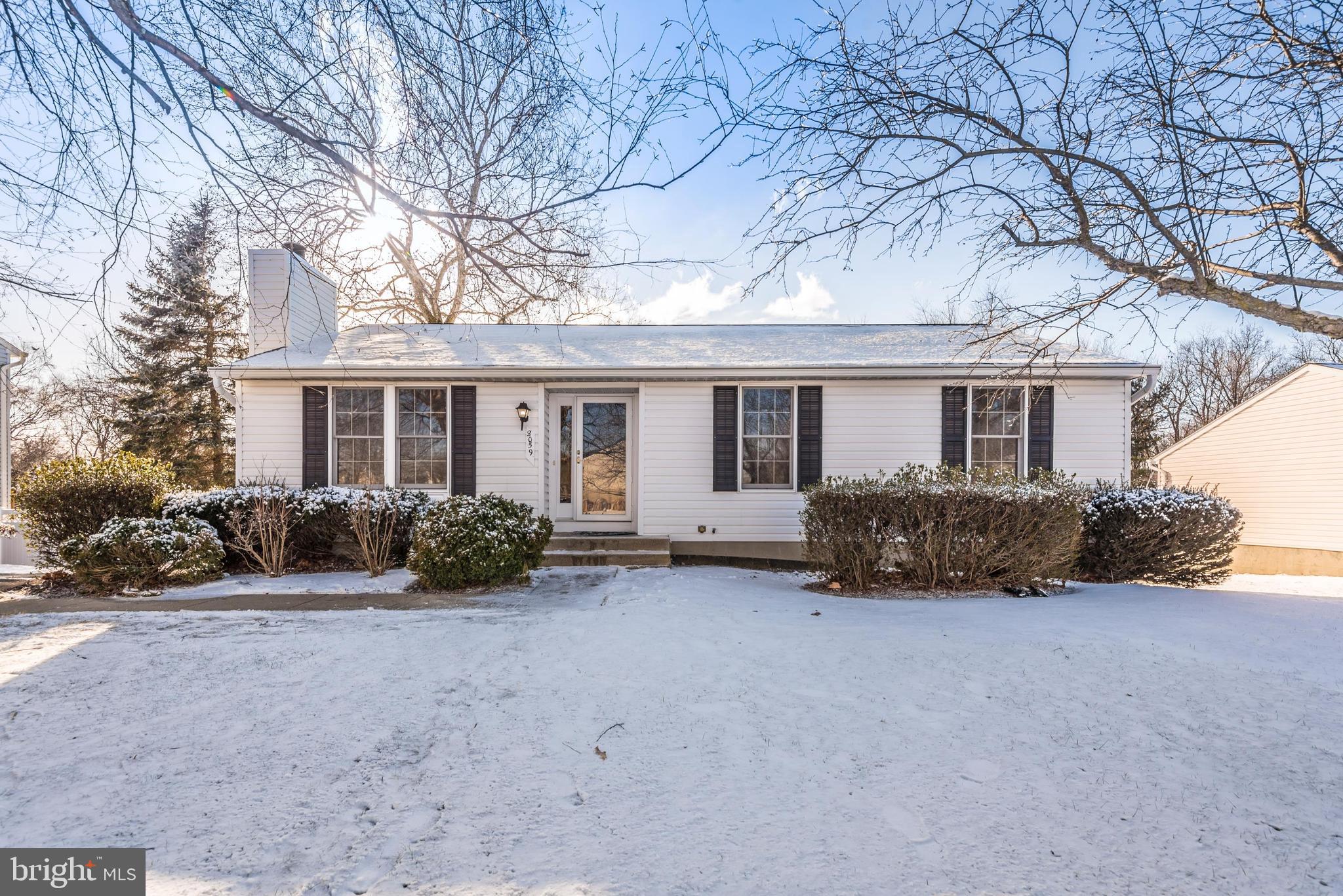 a view of a house with a yard covered in snow