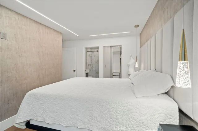 a large white bed in a white room