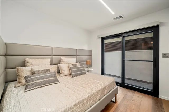 a bedroom with bed and a large window