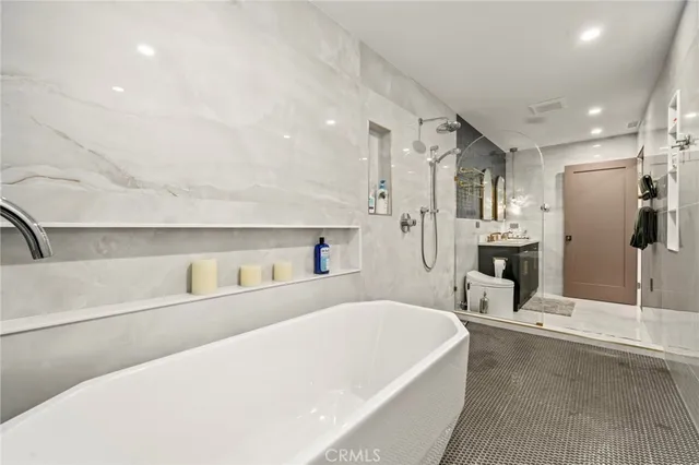 a large white tub sitting in a bathroom