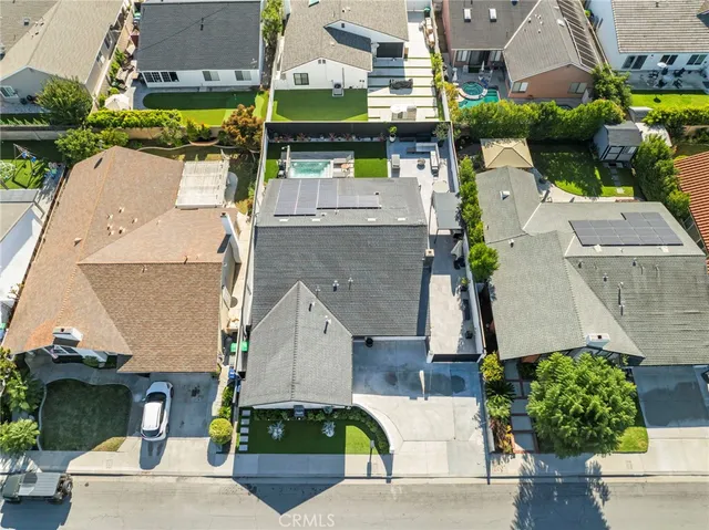 an aerial view of a houses with yard