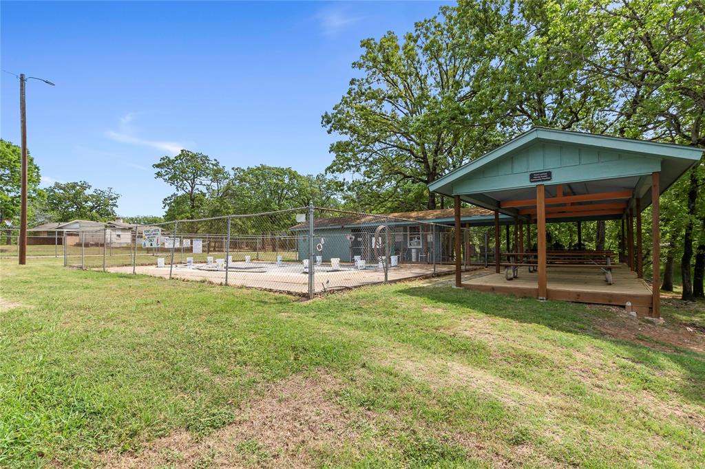5706 Point La Vista Road Malakoff, TX 75148 - Photo 27 of 28 a view of a swimming pool with a table and chairs under an umbrella