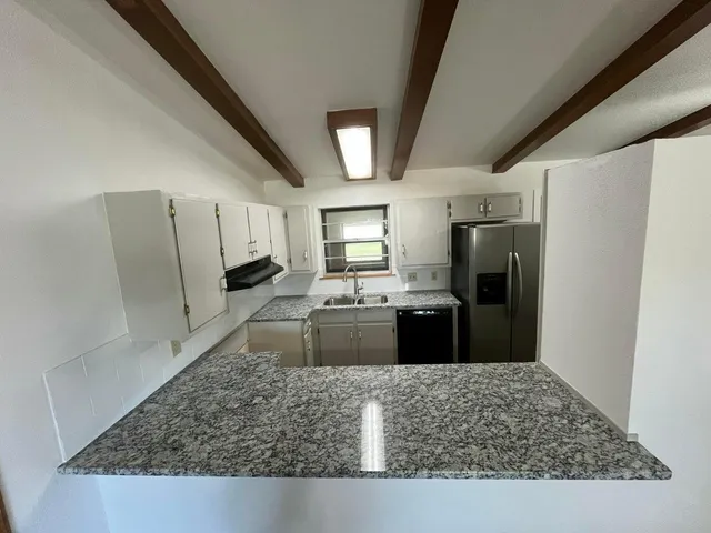 a kitchen with a refrigerator sink and stove