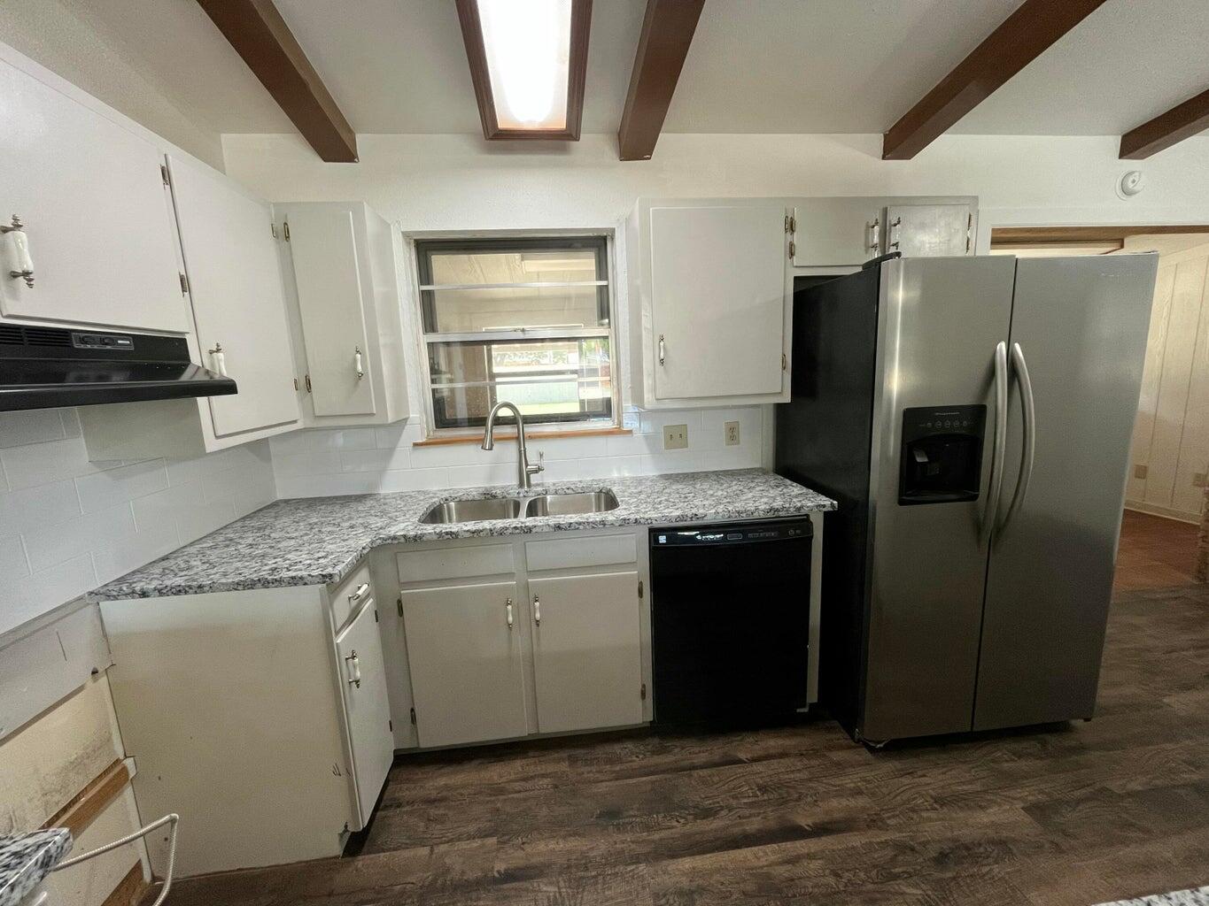 1307 Garland Plainview, TX 79072 - Photo 6 of 23 a kitchen with stainless steel appliances granite countertop a refrigerator a sink a stove and island