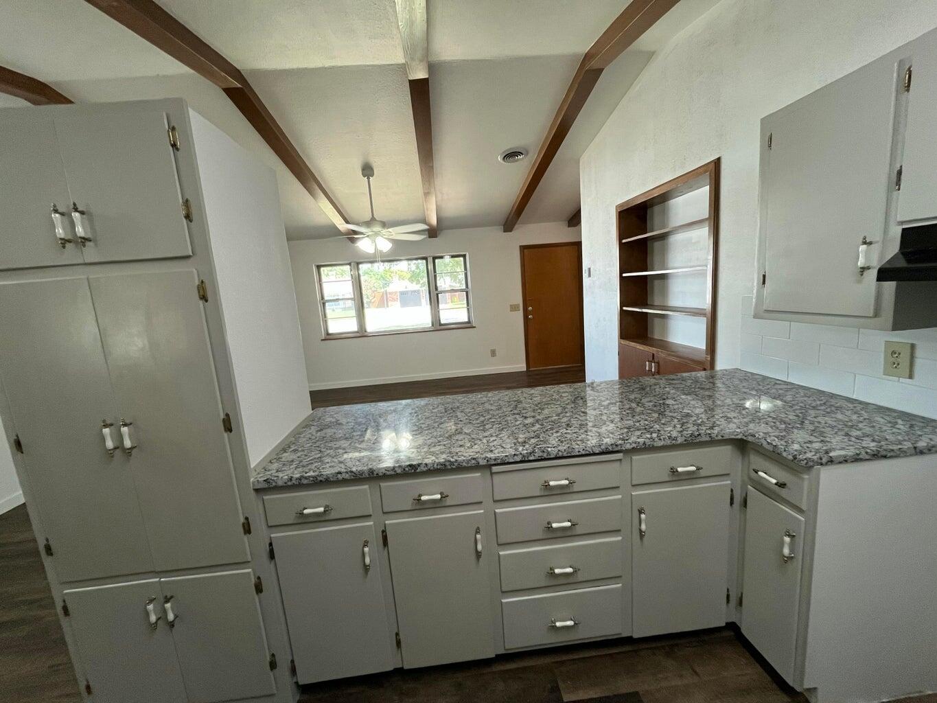 1307 Garland Plainview, TX 79072 - Photo 7 of 23 a kitchen with granite countertop cabinets stainless steel appliances a sink and a counter top space