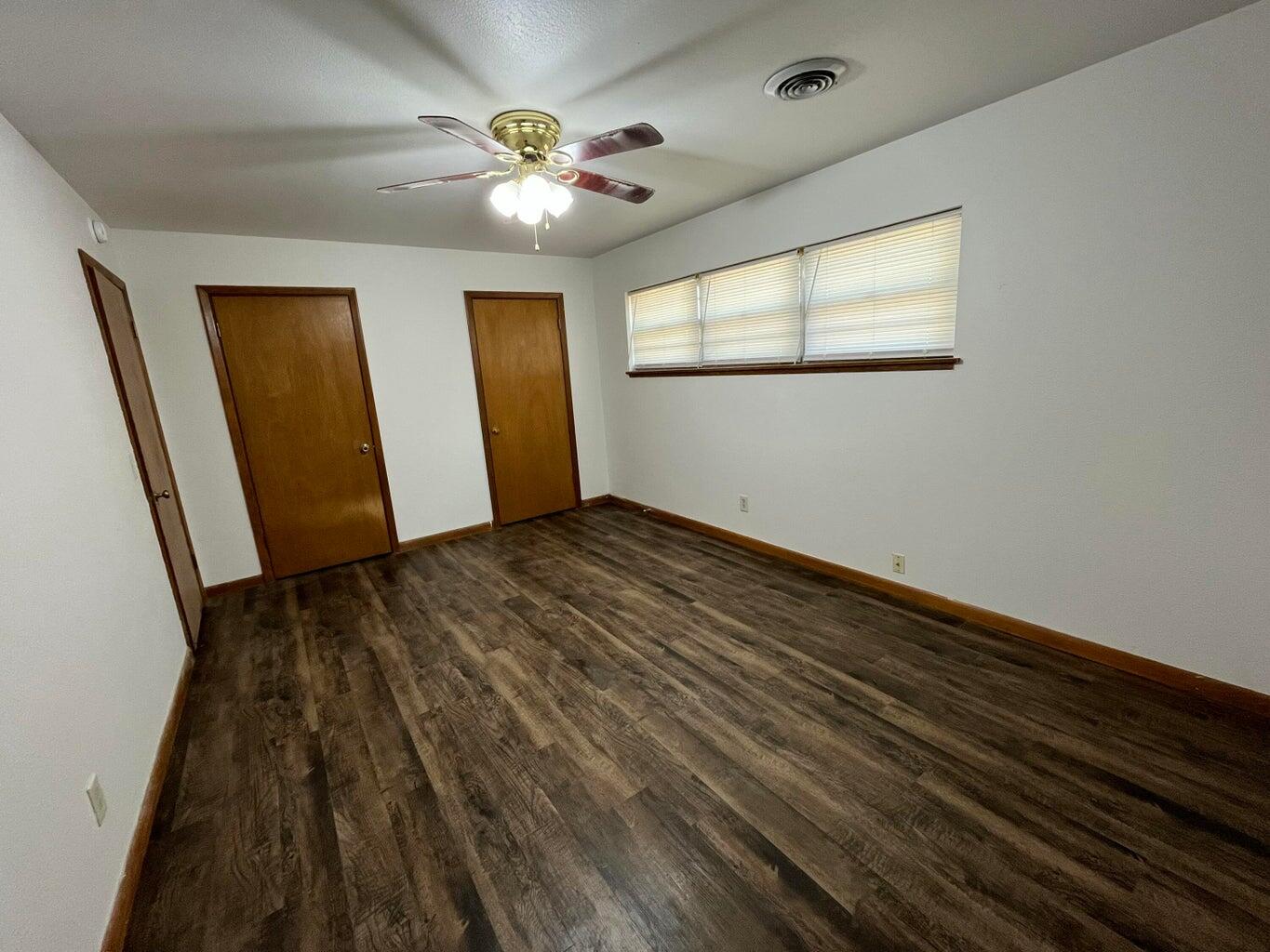 1307 Garland Plainview, TX 79072 - Photo 10 of 23 wooden floor in an empty room with a window