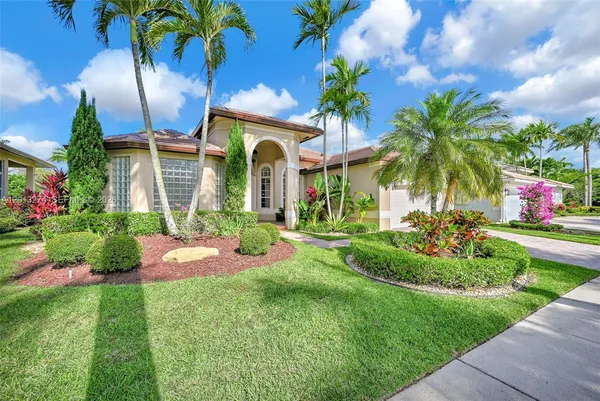 a front view of a house with a garden