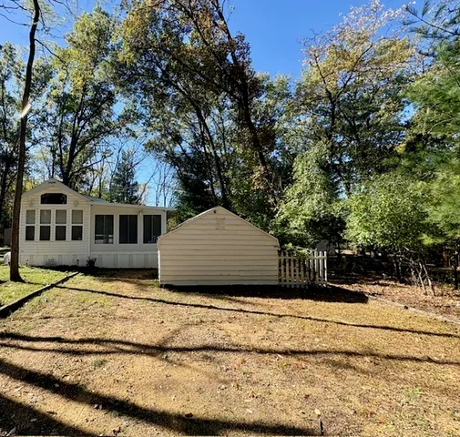 a house that has a tree in front of it