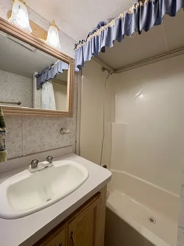 a bathroom with a toilet and a shower curtain