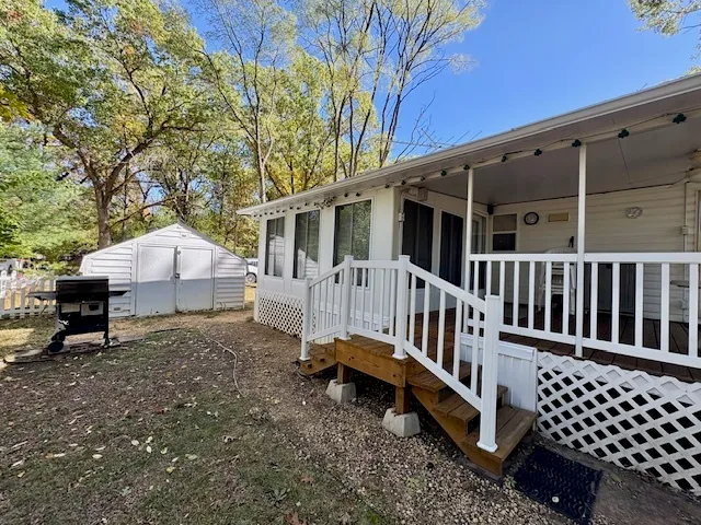 a view of a house with a yard and furniture
