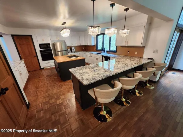 a kitchen with a table chairs sink and cabinets