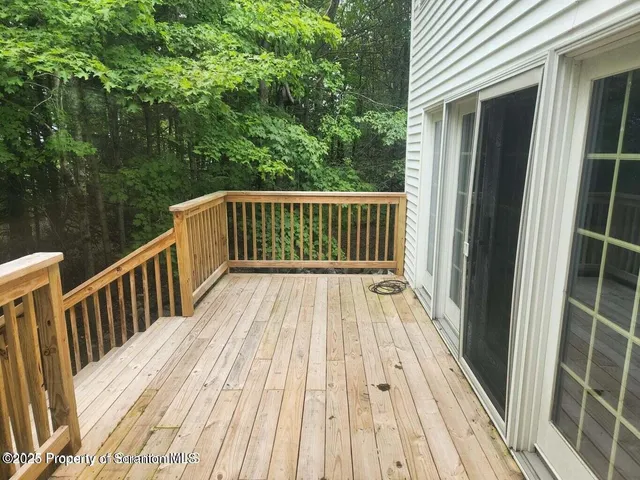 a view of a wooden fence and trees