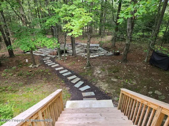 a view of kitchen with refrigerator and window