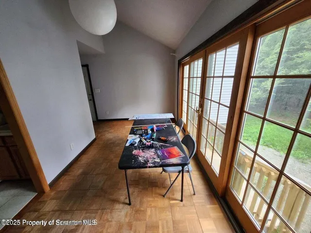 a view of a hallway with furniture and window