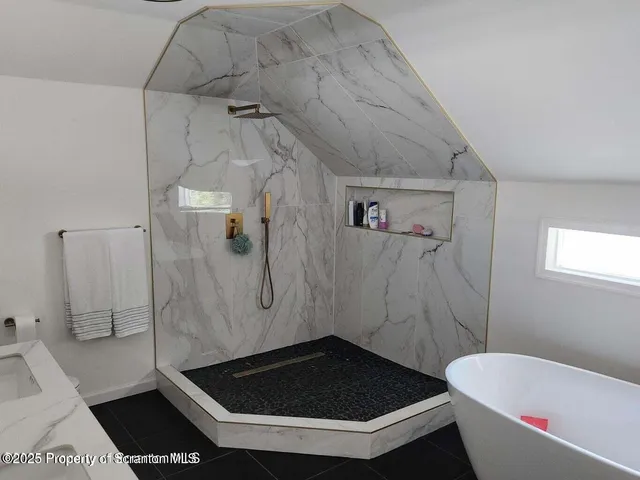 a white bath tub sitting in a bathroom
