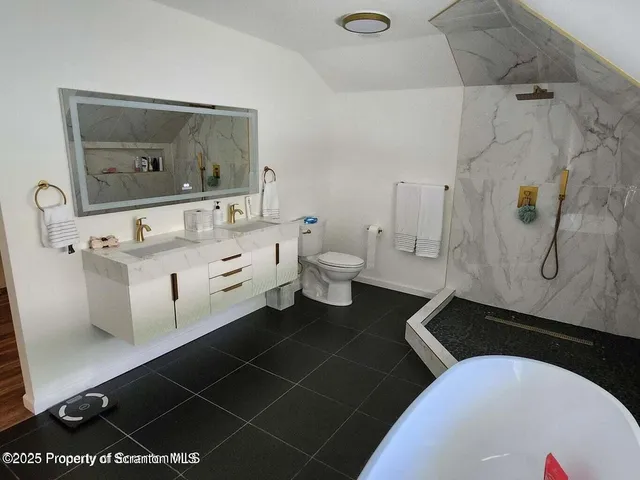 a bedroom with a bed and a mirror