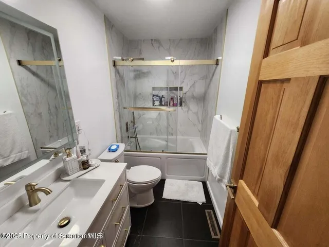 a bathroom with a sink mirror vanity and toilet