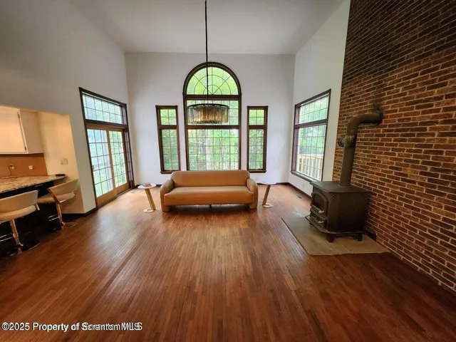 a living room with a bed and a large window