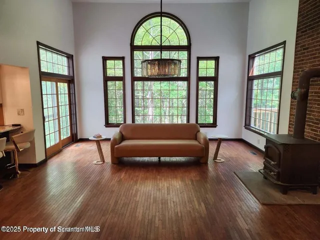 a living room with furniture and a floor to ceiling window