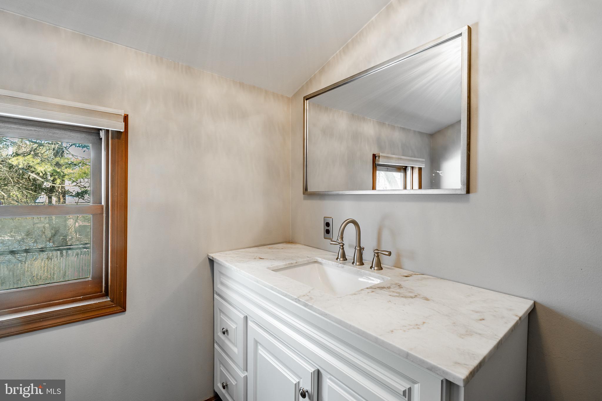 121 West Boot Road West Chester, PA 19380 - Photo 27 of 38 a bathroom with a sink a vanity and a mirror