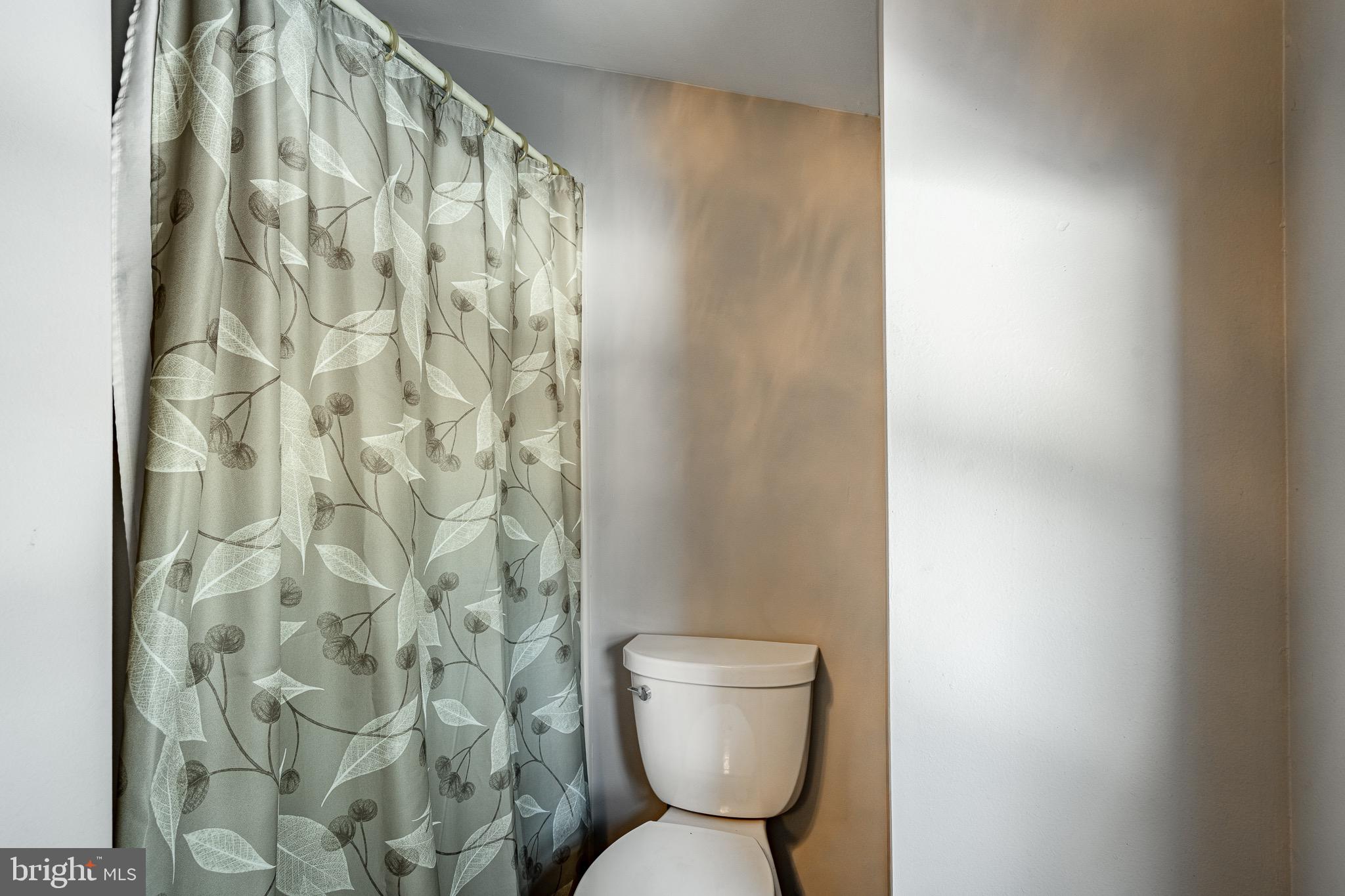 121 West Boot Road West Chester, PA 19380 - Photo 28 of 38 a white toilet sitting next to a shower curtain