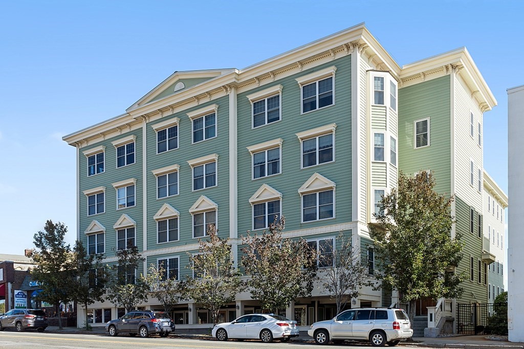 426 Main Street, Unit 205 Melrose, MA 02176 - Photo 1 of 26 a front view of a building with lot of cars and trees