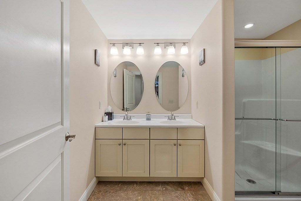 426 Main Street, Unit 205 Melrose, MA 02176 - Photo 11 of 26 a bathroom with a double vanity sink and mirror