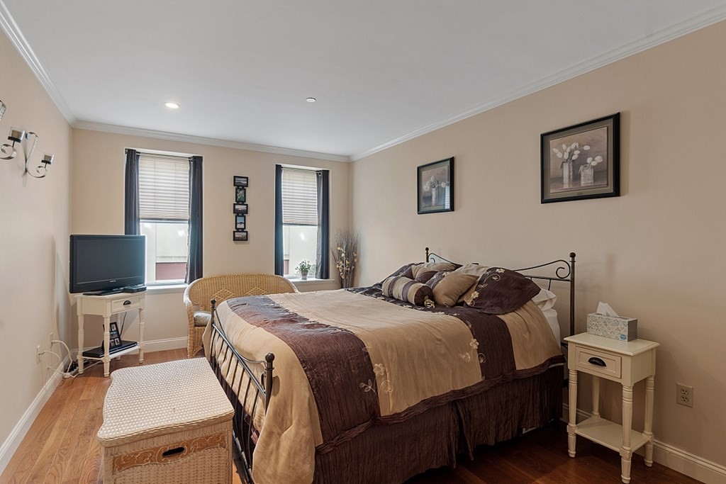 426 Main Street, Unit 205 Melrose, MA 02176 - Photo 13 of 26 a bedroom with a bed and a flat screen tv