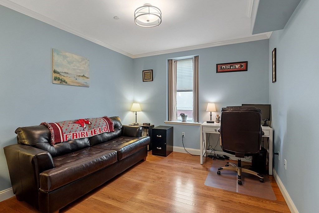 426 Main Street, Unit 205 Melrose, MA 02176 - Photo 17 of 26 a view of a livingroom with workspace and a couch