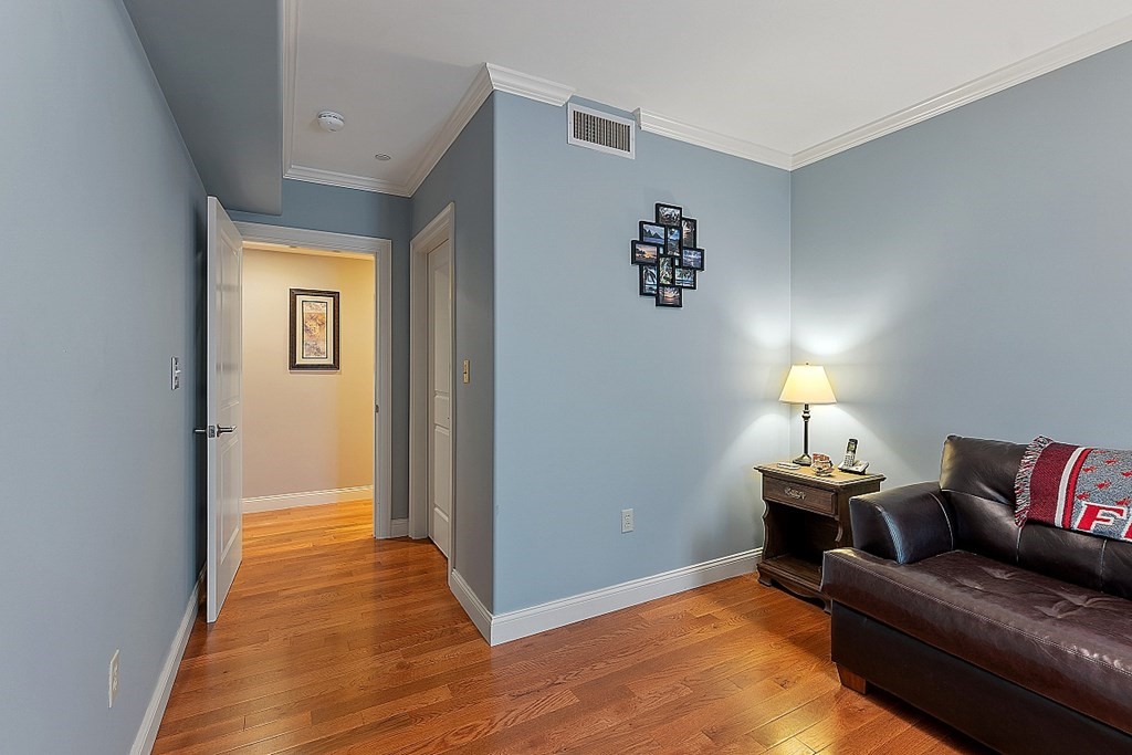 426 Main Street, Unit 205 Melrose, MA 02176 - Photo 18 of 26 a living room with furniture and a wooden floor