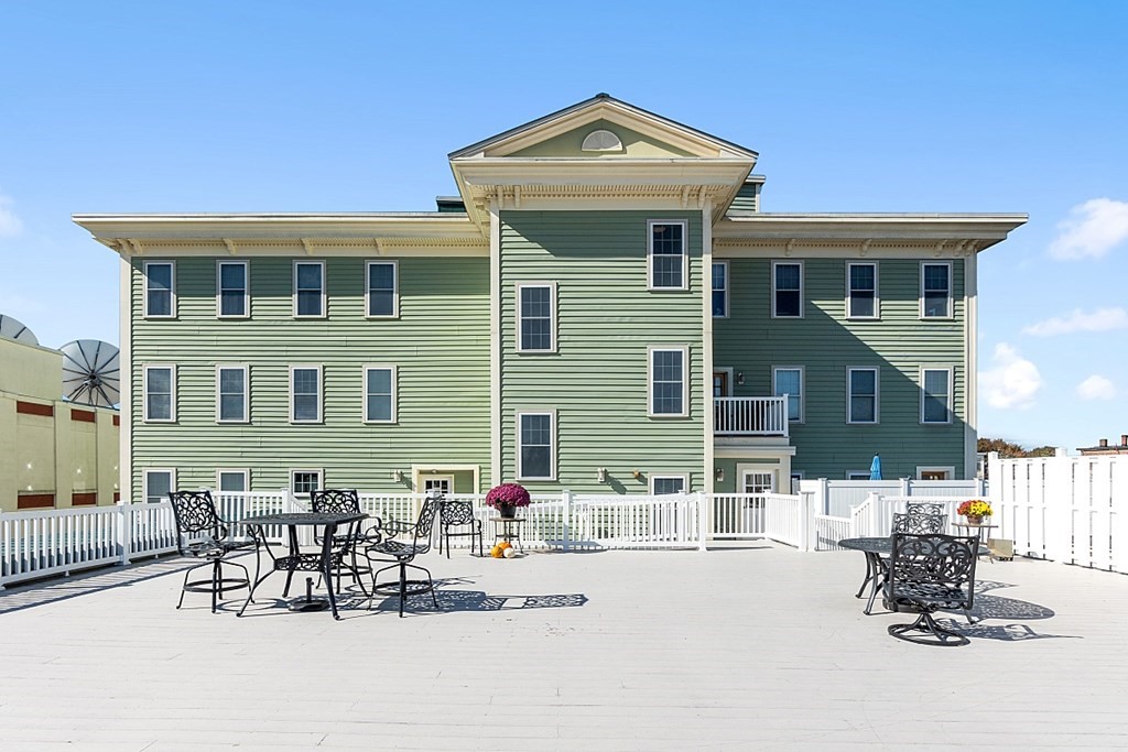 426 Main Street, Unit 205 Melrose, MA 02176 - Photo 20 of 26 a front view of a house with patio