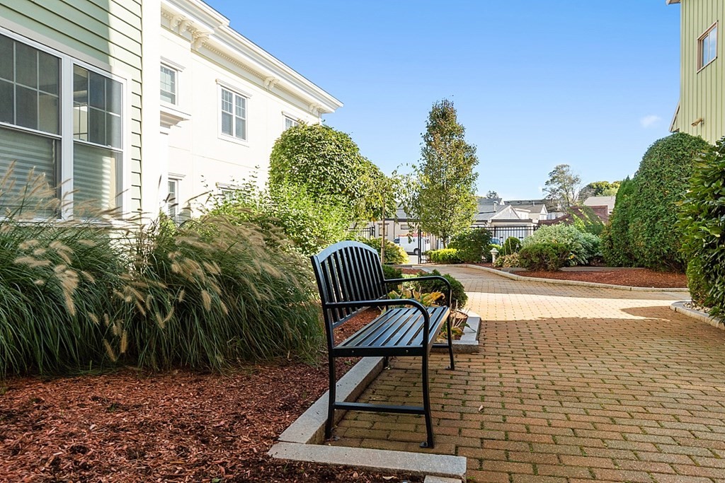426 Main Street, Unit 205 Melrose, MA 02176 - Photo 21 of 26 a view of a chair and table in the backyard of the house