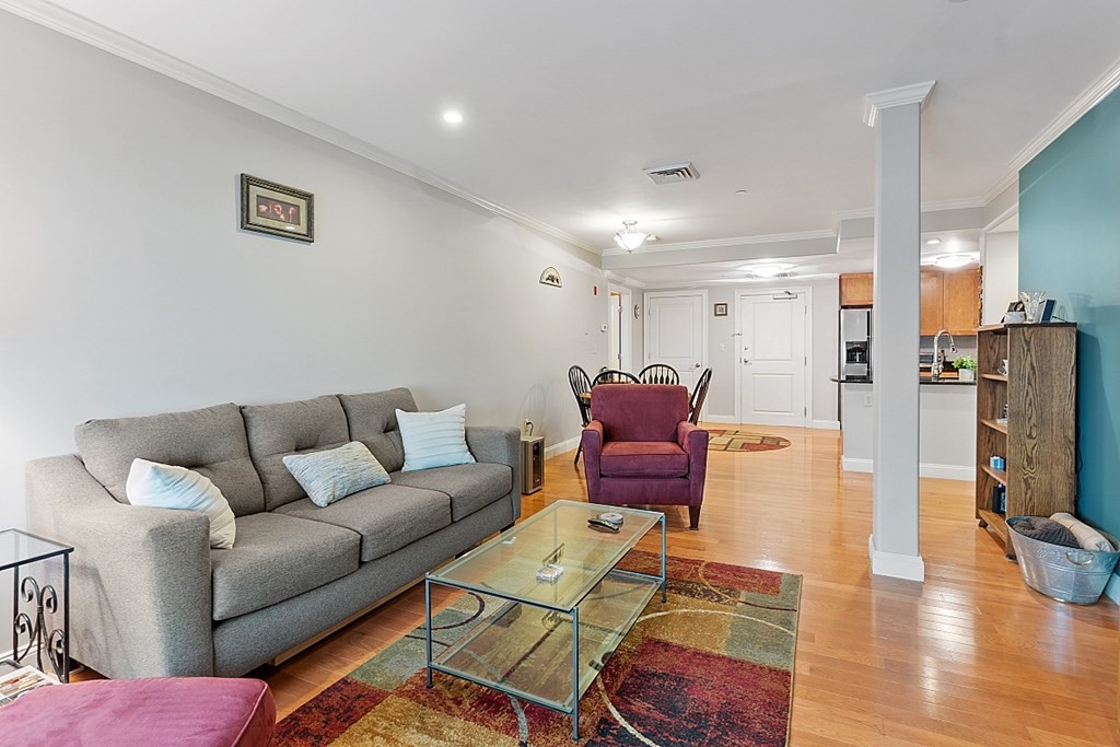 426 Main Street, Unit 205 Melrose, MA 02176 - Photo 9 of 26 a living room with furniture a flat screen tv and a table