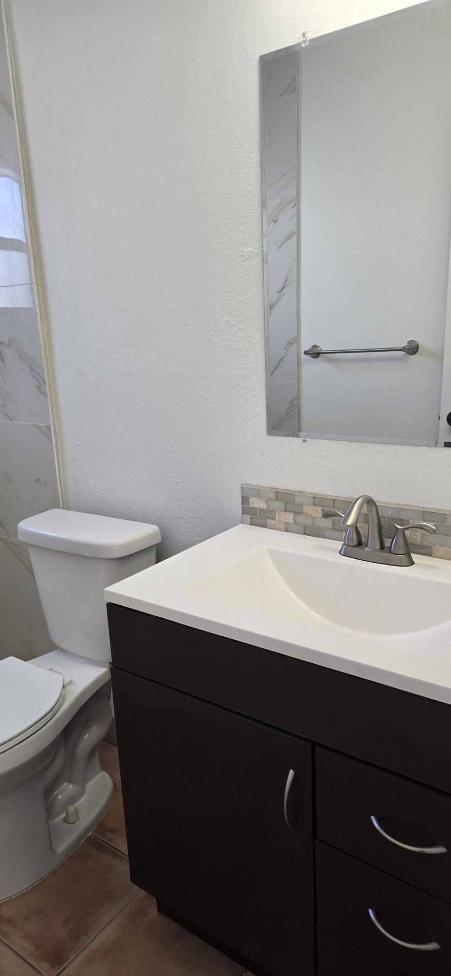 186 Burgandy Way Delray Beach, FL 33484 - Photo 11 of 26 a bathroom with a sink and a toilet