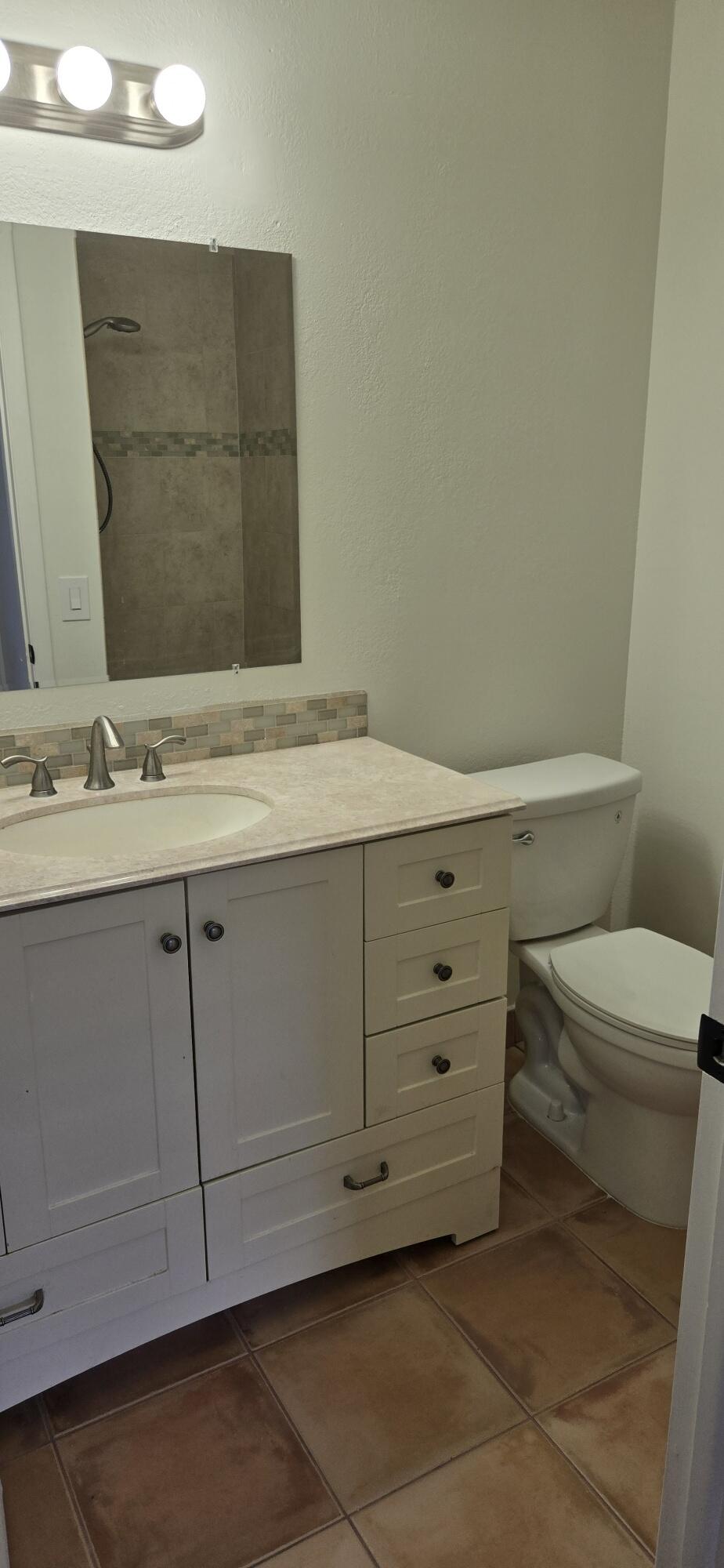 186 Burgandy Way Delray Beach, FL 33484 - Photo 22 of 26 a bathroom with a sink a toilet and vanity