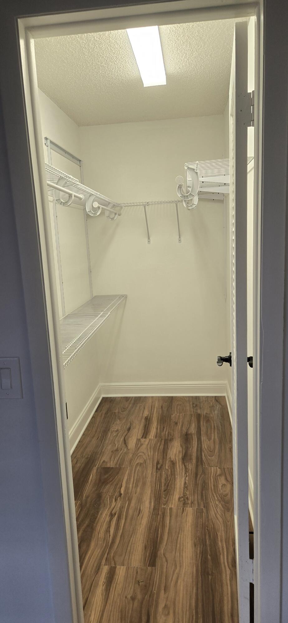 186 Burgandy Way Delray Beach, FL 33484 - Photo 26 of 26 a view of walk in closet with empty racks