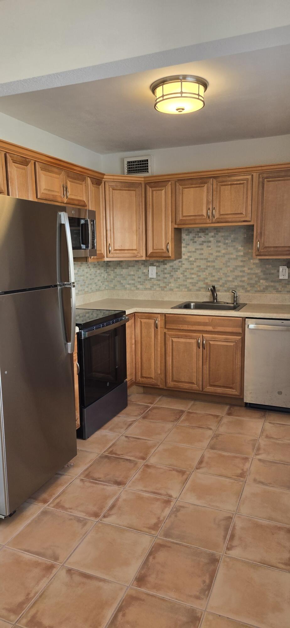 186 Burgandy Way Delray Beach, FL 33484 - Photo 4 of 26 a view of kitchen with granite countertop cabinets and stainless steel appliances