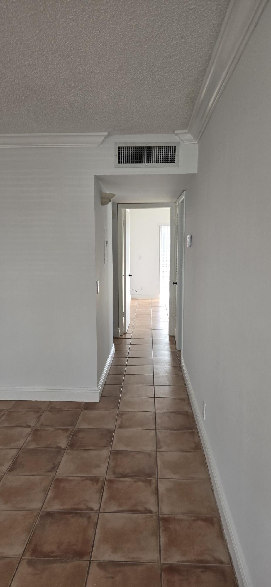 186 Burgandy Way Delray Beach, FL 33484 - Photo 9 of 26 a view of a hallway with wooden floor