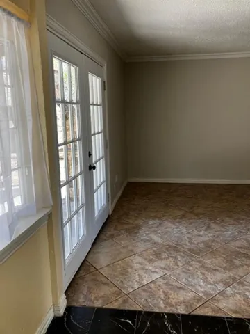 en empty room with windows and ceiling fan