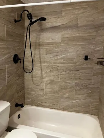 a bathroom with a toilet and shower