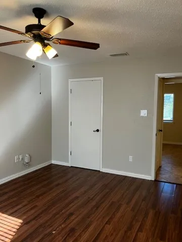 a bathroom with a granite countertop sink toilet and a mirror
