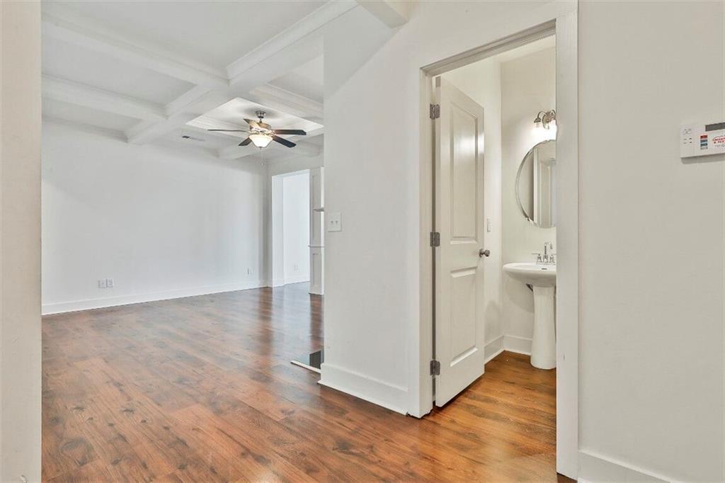 7641 Squire Court Fairburn, GA 30213 - Photo 17 of 33 an empty room with wooden floor and a ceiling fan
