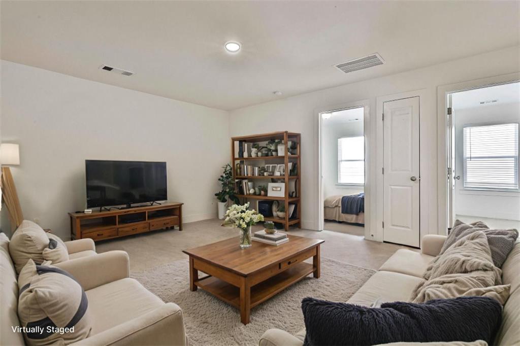 7641 Squire Court Fairburn, GA 30213 - Photo 20 of 33 a living room with furniture and a flat screen tv