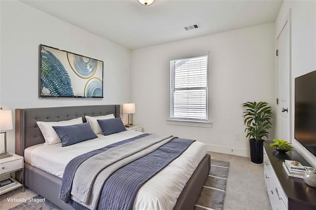 7641 Squire Court Fairburn, GA 30213 - Photo 27 of 33 a bedroom with furniture and a potted plant