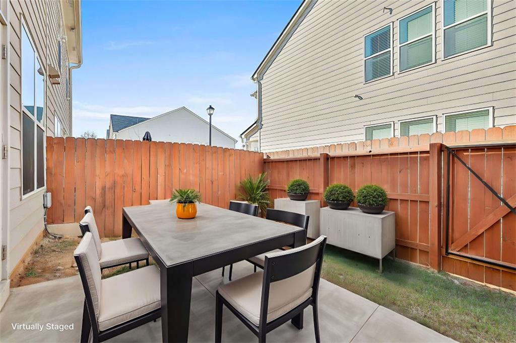 7641 Squire Court Fairburn, GA 30213 - Photo 32 of 33 a backyard of a house with barbeque oven table and chairs