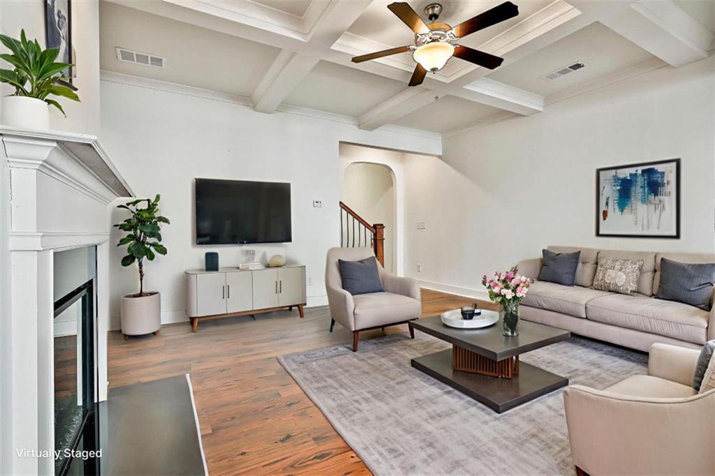 7641 Squire Court Fairburn, GA 30213 - Photo 7 of 33 a living room with furniture a flat screen tv and a potted plant